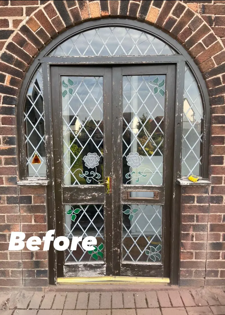 Before: An old dark timber double door with leaded glass in a brick arch